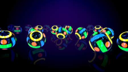 Festive 3d illutration of a group of neon looking colorful balls rolling on a flat surface in several lines in the black background. They create the spirit of innovation, fun and optimism.の写真素材