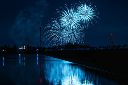 Fireworks on Black background in the japan summer season nighttime. Reflate lake water with colourful.の写真素材