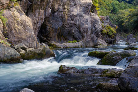 Beautiful rive with fresh blue water and long rock. In japan forestの写真素材