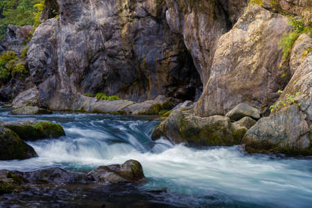 Beautiful rive with fresh blue water and long rock. In japan forestの写真素材