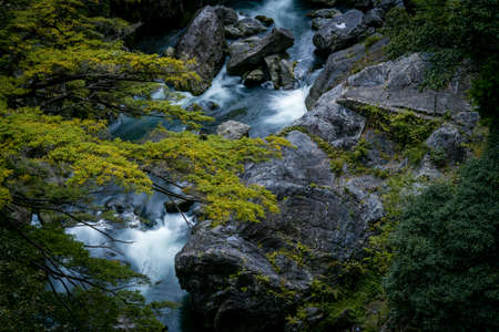 Beautiful rive with fresh blue water and long rock. In japan forestの写真素材
