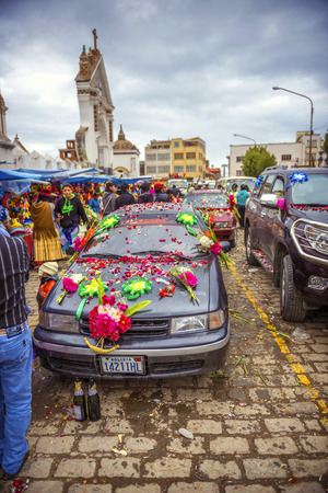 COPACABANA, BOLIVIA - JANUARY 3  Unidentified cars outside the basilica of the Virgen de la Candelaria for the weekend blessing of automobiles January 03, 2014 in Copacabana, Bolivia, South America のeditorial素材