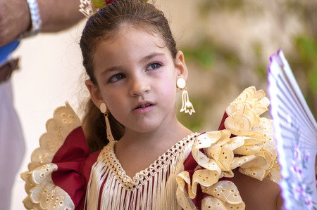 MALAGA, SPAIN - AUGUST, 14: Little girls in flamenco style dress at the Malaga August Fair on August, 14, 2009 in Malaga, Spainのeditorial素材