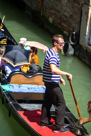 VENICE, ITALY - JULY 12 : Gondolier plying his trade in Venice Italy on July 12, 2014のeditorial素材