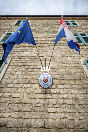 MONTENEGRO, KOTOR - JULY 17, 2014: Flags in the croatian consulate in Kotor, Montenegroのeditorial素材