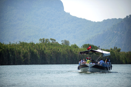 TURKEY, DALYAN, MUGLA - JULY 19, 2014: Touristic River Boats with tourists in the mouth of the Dalyan Riverのeditorial素材