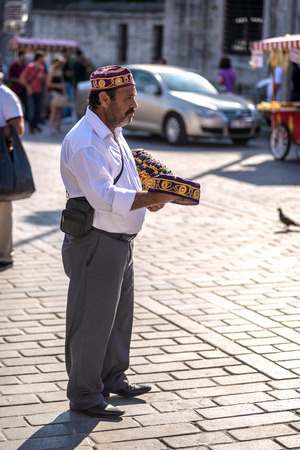 ISTANBUL - JULY 4: Turkish typical hat seller on the streets of Istanbul on July 4, 2014 in Istanbul, Turkeyのeditorial素材