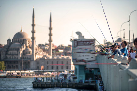 ISTANBUL, TURKEY - OCT. 09: Fishermen on Galata bridge of Istambul on oct, 09, 2013 in Istanbul, Turkey. Galata Bridge is a bridge that crosses the Golden Horn in Istanbul.のeditorial素材