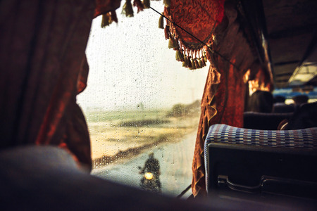 Multiple drops of water on a bus window, in the road to Phnom Penh, Cambodiaの写真素材