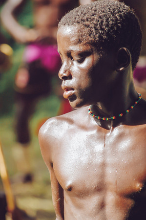 SENEGAL - SEPTEMBER 19: Men, women and kids in the traditional struggle wrestle clothes of Senegal dancing before fighting, on September 19, 2007 in Casamance, Senegalのeditorial素材