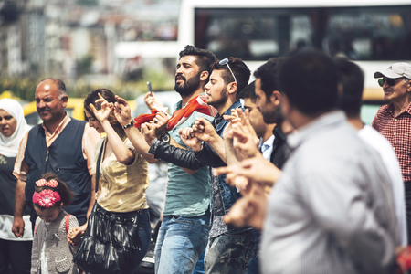 ISTANBUL - MAY 20: Young people dancing typical turkish dances in the street on May 20, 2015 in Istanbul; Turkeyのeditorial素材
