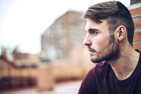 Handsome caucasian young man in casual clothes in urban environmentの写真素材