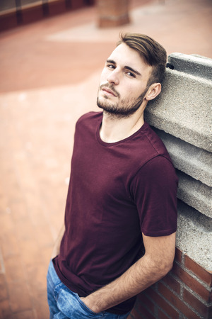 Handsome caucasian young man in casual clothes in urban environmentの写真素材