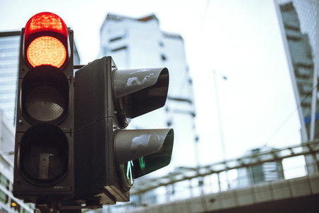 Red traffic light and green pedestrian light in Hong Kong street. Horizontal outdoors shot. の写真素材