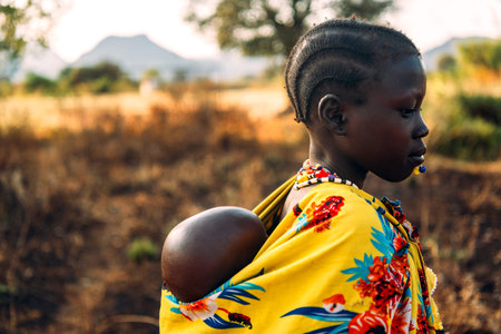 BOYA TRIBE, SOUTH SUDAN - MARCH 10, 2020: Girl in traditional colorful garment of Boya Tribe...