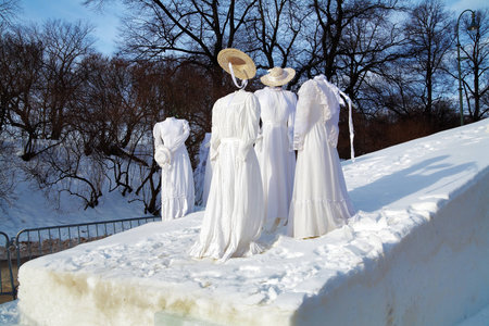 Figures from the ladies dresses with straw hats on a ski slope - Installation in Oslo, Norwayのeditorial素材