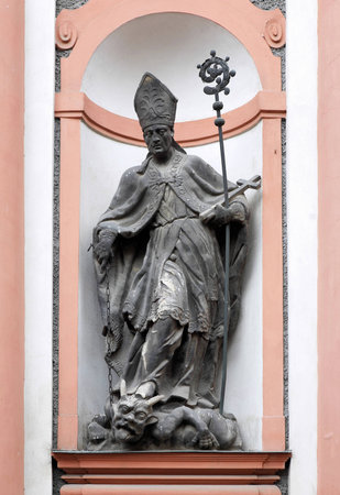 Statue of St Adalbert, trampling the devil, on the facade of the church of St  John of Nepomuk in Kutna Hora, Czech Republicのeditorial素材