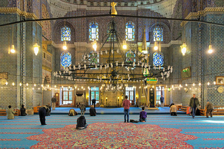 Men during the praying in the Yeni Mosque (New Mosque) in Istanbul, Turkeyのeditorial素材