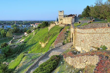 People sitting on the wall of the Kalemegdan fortress in Belgrade during sunset, Serbiaのeditorial素材