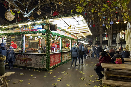 BUDAPEST, HUNGARY - DECEMBER 6, 2016: Market stalls with the traditional Hungarian food and drinks at the Christmas Fair and Winter Festival on the Vorosmarty Square in dusk.のeditorial素材