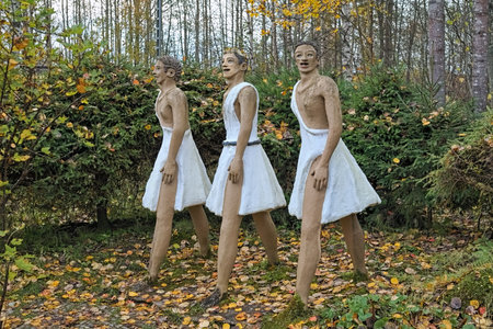 PARIKKALA, FINLAND - OCTOBER 9, 2011: Sculptures of three men in ancient dress by ITE-artist Veijo Ronkkonen (1944-2010) in his sculpture park. The park contains about 560 concrete statues.のeditorial素材