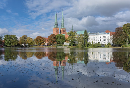 View of Lubeck Cathedral from Muhlenteich (Mill pond) in autumn, Germany. The cathedral was started in 1173 and consecrated in 1247.のeditorial素材