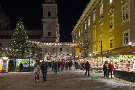 SALZBURG, AUSTRIA - DECEMBER 11, 2017: Christmas market at Residenzplatz square close to Salzburg Cathedral in twilight. The origins of the Salzburg Christmas market go back to the late 15th century.のeditorial素材