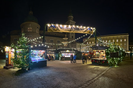 SALZBURG, AUSTRIA - DECEMBER 11, 2017: Christmas market at the Residenzplatz square close to Salzburg Cathedral in night. The origins of the Salzburg Christmas market go back to the late 15th century.のeditorial素材