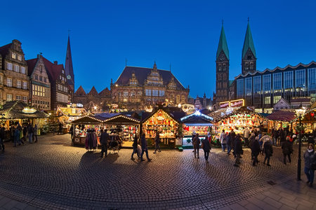 BREMEN, GERMANY - DECEMBER 4, 2018: Panoramic view of Christmas Market at Market Square in dusk. The square is surrounded by Church of Our Lady, Town Hall, Bremen Cathedral and Parliament of Bremen.のeditorial素材