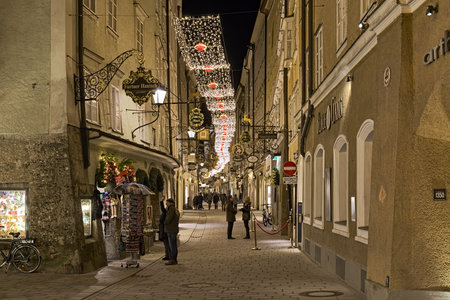 SALZBURG, AUSTRIA - DECEMBER 11, 2017: Getreidegasse street in Old Town with Christmas illumination. The street is characterised by numerous town houses side by side with its wrought iron guild signs.のeditorial素材