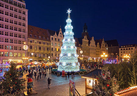 WROCLAW, POLAND - DECEMBER 9, 2019: The city's main Christmas tree at Christmas market on the Market Square in dusk. Wroclaw Christmas Market is regarded as one of the best Christmas markets in Polandのeditorial素材