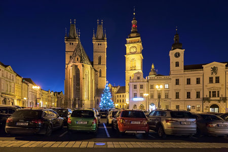 HRADEC KRALOVE, CZECH REPUBLIC - DECEMBER 10, 2019: Cathedral of Holy Spirit, White Tower and fragment of Old Town Hall on Great Square in twilight. Christmas tree is located in front of the cathedralのeditorial素材