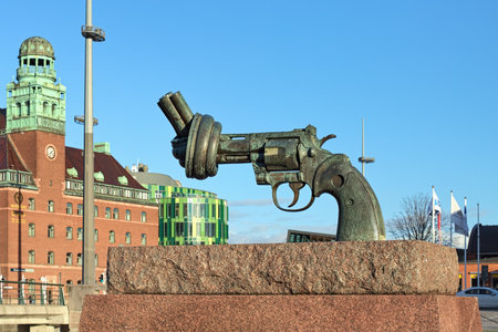 MALMO, SWEDEN - DECEMBER 13, 2015: The Knotted Gun or Non-Violence sculpture. The sculpture by Carl Fredrik Reutersward was unveiled in 1985. Fragment of Central Post Office is visible in background.のeditorial素材