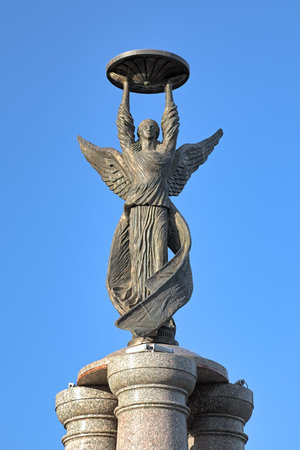 TAGANROG, RUSSIA - SEPTEMBER 27, 2011: Sculpture of guardian angel on the top of the monument to commemorate the 300th anniversary of the city. The sculpture by David Begalov was installed in 2009.のeditorial素材