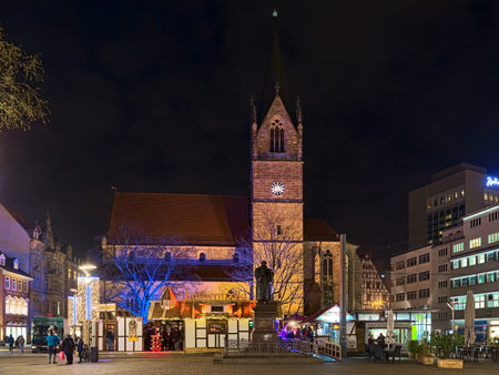 ERFURT, GERMANY - DECEMBER 13, 2018: Small christmas market on Anger square between Luther Monument and Merchant's church (Kaufmannskirche) in night. The monument was unveiled on October 30, 1889.のeditorial素材
