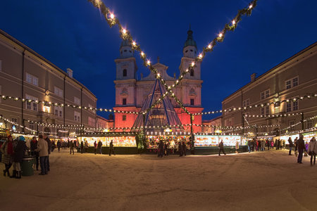 SALZBURG, AUSTRIA - DECEMBER 11, 2017: Christmas market at Cathedral Square in front of Salzburg Cathedral. The origins of Salzburg Christmas market go back to the 15th century.のeditorial素材