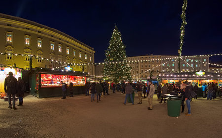 SALZBURG, AUSTRIA - DECEMBER 11, 2017: Christmas market at Residenzplatz square in night. The origins of the Salzburg Christmas market go back to the late 15th century.のeditorial素材