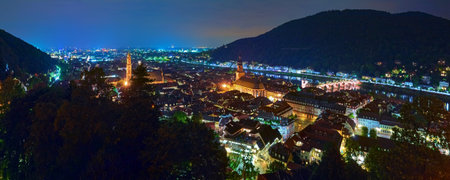 Heidelberg, Germany. Night high angle panoramic view of Heidelberg Old Town with Jesuit Church, Church of the Holy Spirit and Old Bridge (Karl Theodor Bridge) across Neckar river.の写真素材