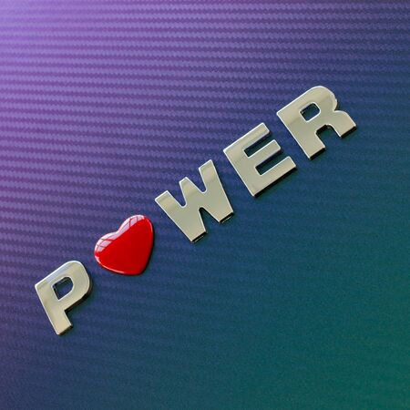 Concept of motor sport, speed, engine power. Letters placed diagonally on carbon fiber background, with red heart symbol replacing the letter oの写真素材