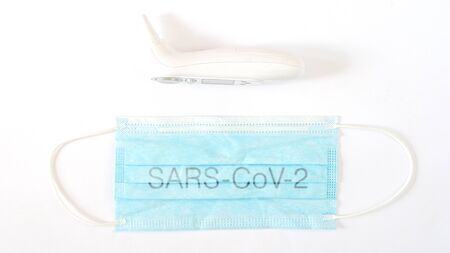 Surgical protective mask with a Sars-Cov-2 and a termometherの写真素材