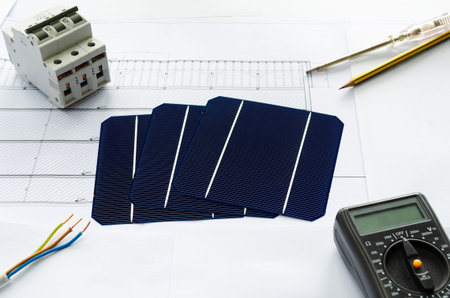 Planing the switch to solar power. Construction plan or blueprint and solar cells with calculator...