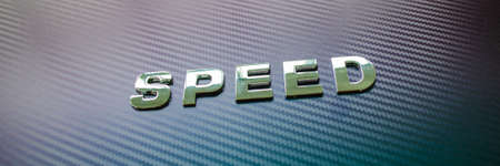 Speed spelled with chrome letters on violet and blue carbon fiber background.の写真素材