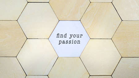 Wooden hexagon missing from puzzle, revealing the words Find Your Passion in a conceptual image of personal growth and motivationの写真素材