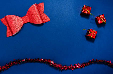 Top view of red christmas decorations in a conceptual image of the coming new year. Over blue background.の写真素材