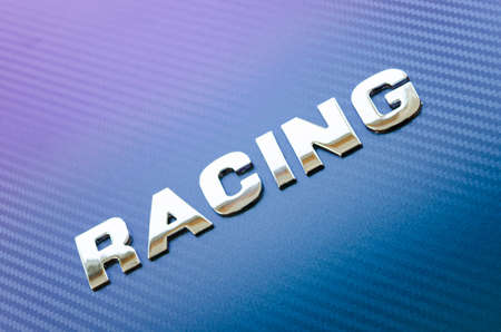 Concept of sport, speed, racing. Letters on carbon fiber backgroundの写真素材