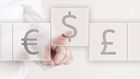Businessman selecting a USA dollar currency instead of eur and British poundの写真素材