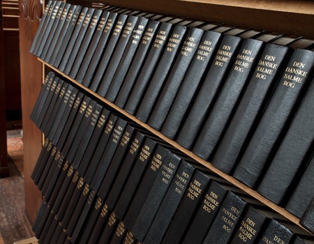 Songbooks linde up on shelves in danish church. の写真素材