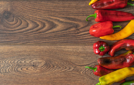 bell pepper in yellow and red colors on oak boardsの写真素材