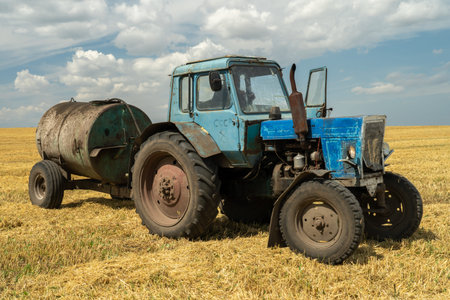 an old rare tractor drove a barrel of diesel fuel to the field, translation of the inscription on...