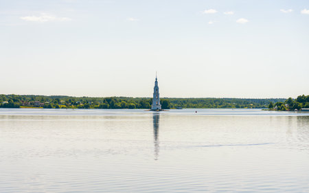 the ancient Russian city of Kalyazin has gone under water, where the bell tower from the flooded church sticks out above the surface of the waterの写真素材